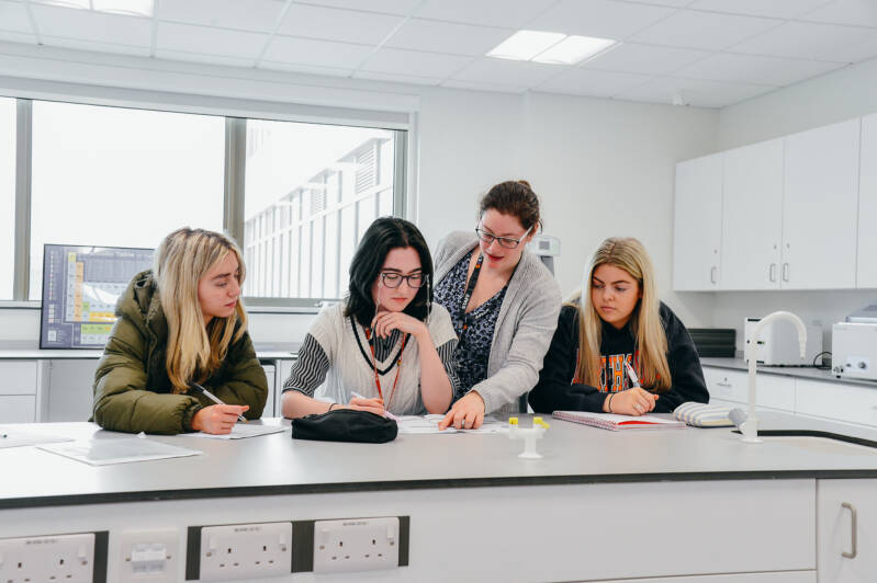 Group of SRC students working together at lab bench